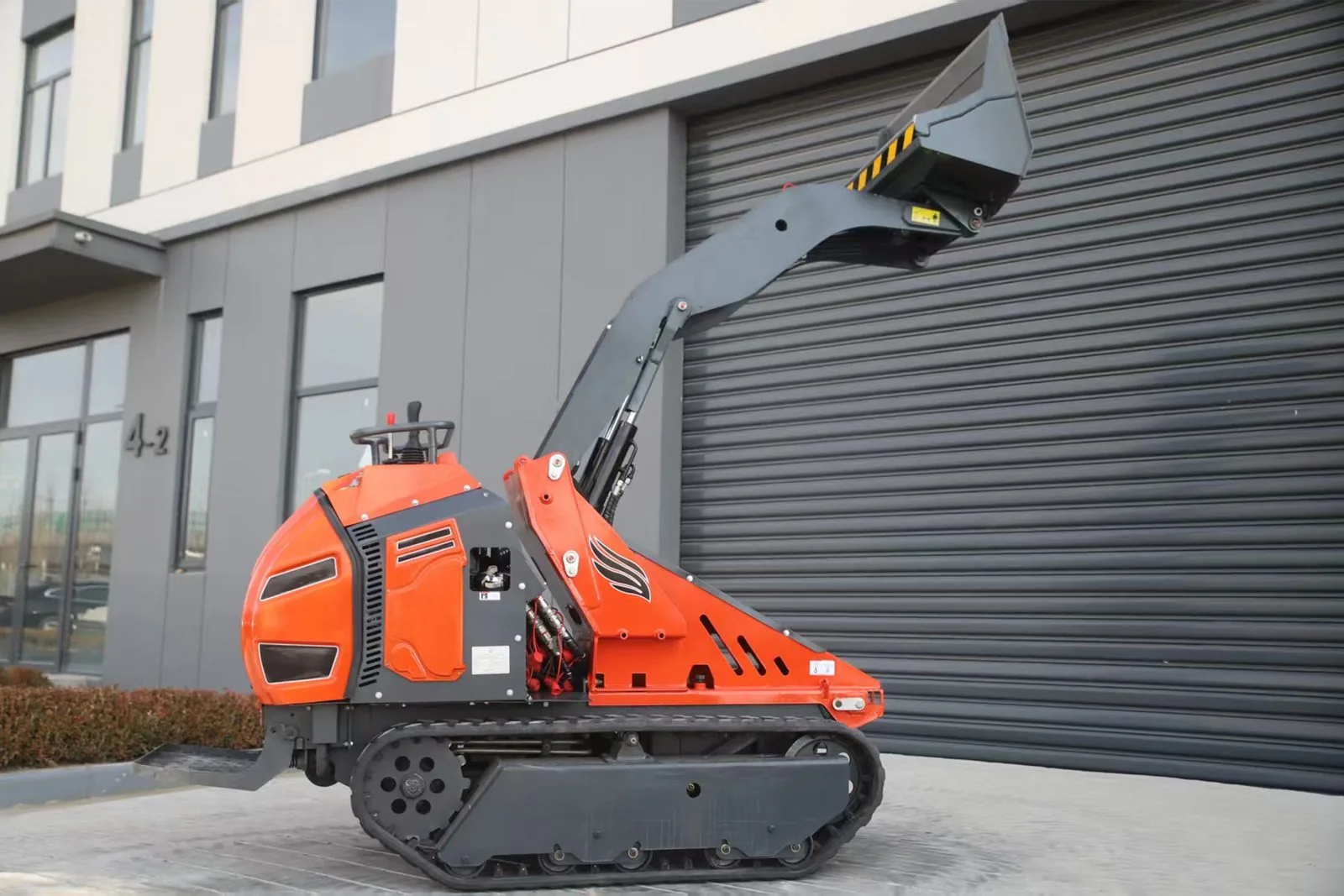 C1200 compact crawler loader in high lift configuration