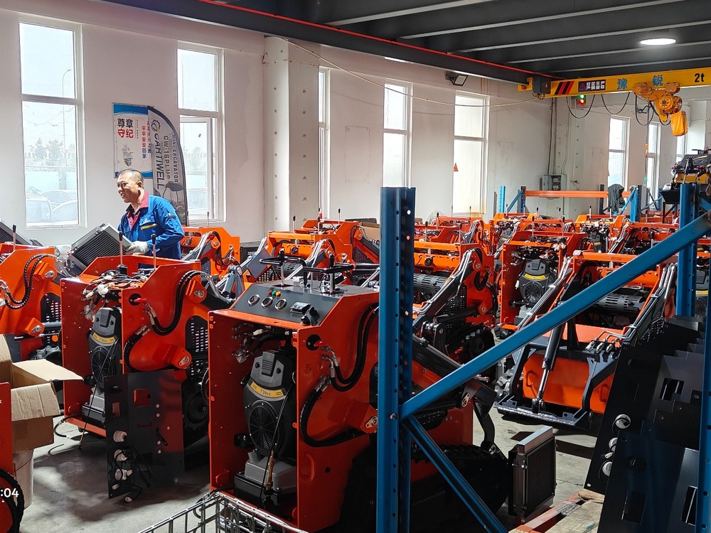 Compact loader machines arranged along a workshop production line