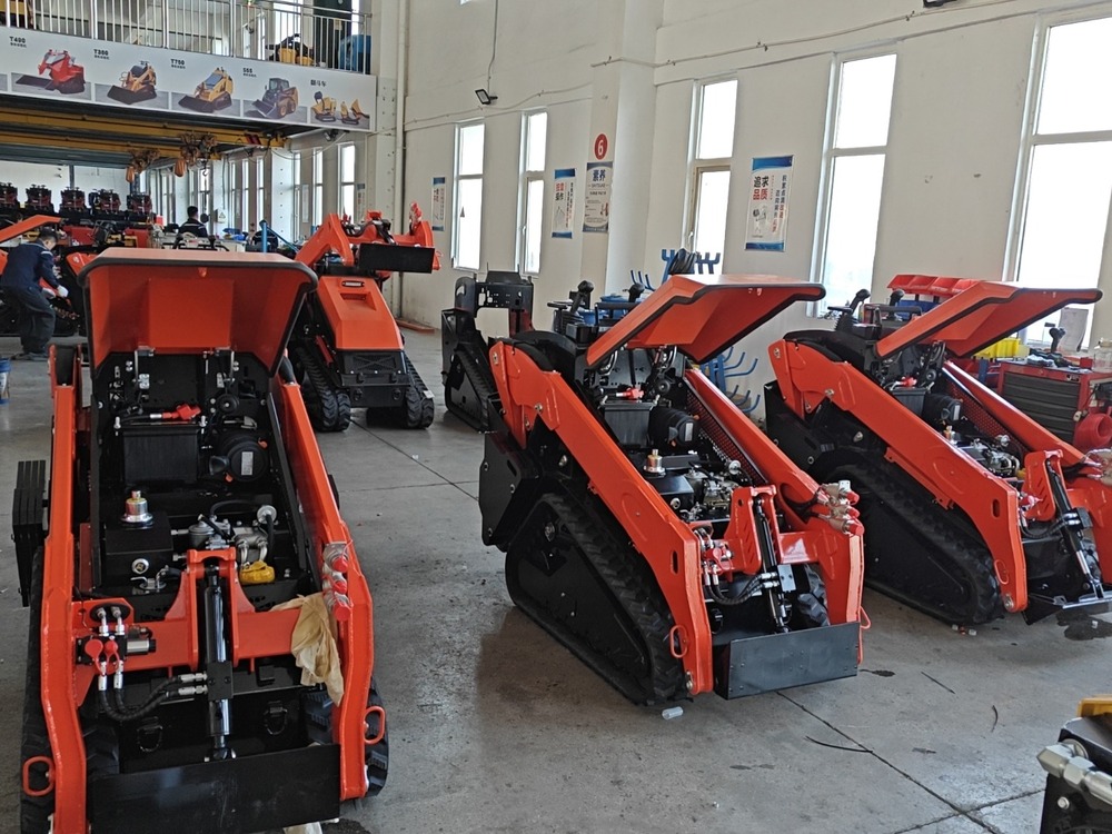 Mini skid steer loaders in different stages of workshop production