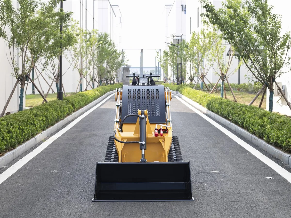 KORVA T360 tracked mini skid steer loader front view with loading bucket