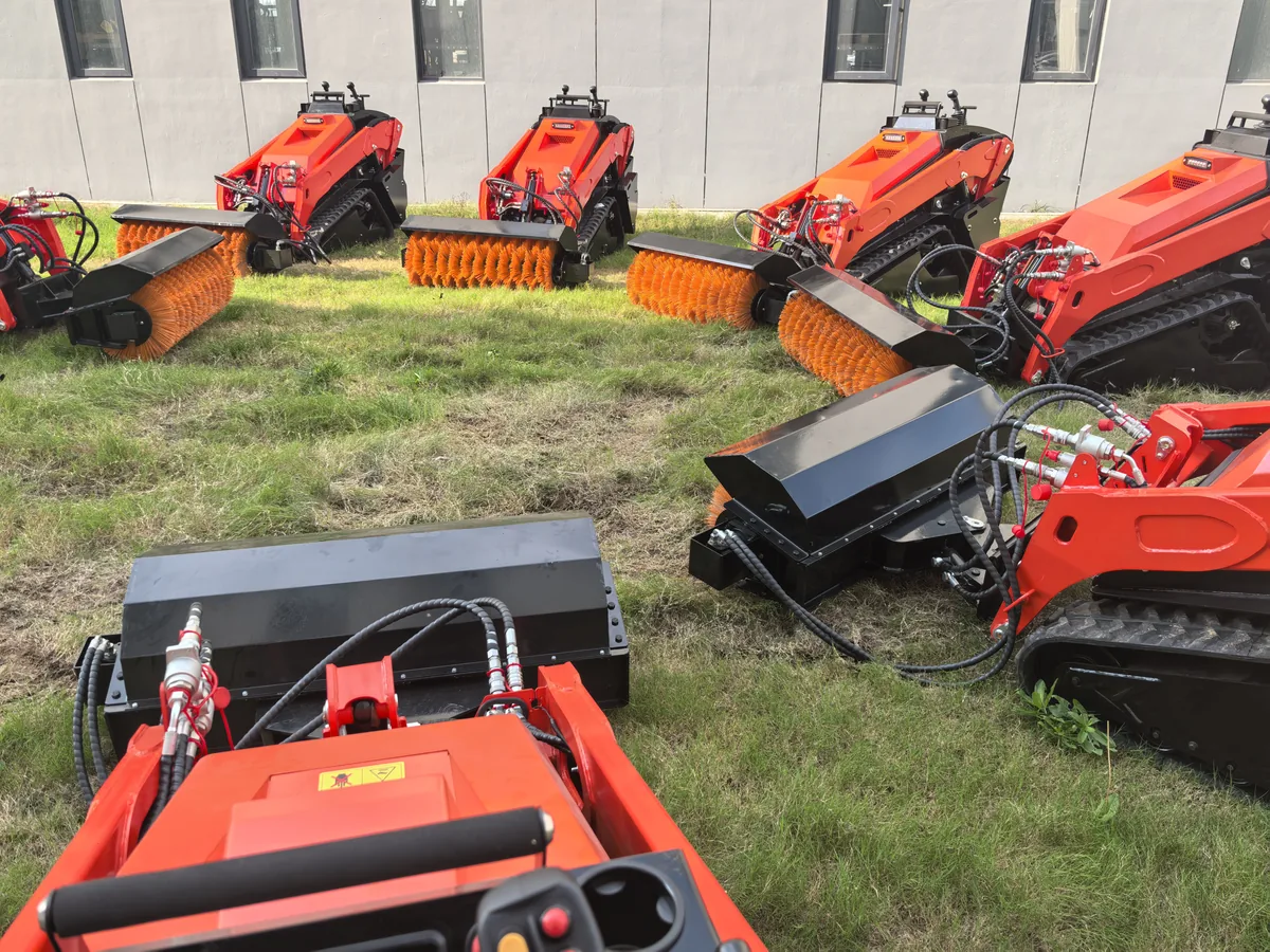 V1000 tracked skid steer loaders with hydraulic sweeper attachments